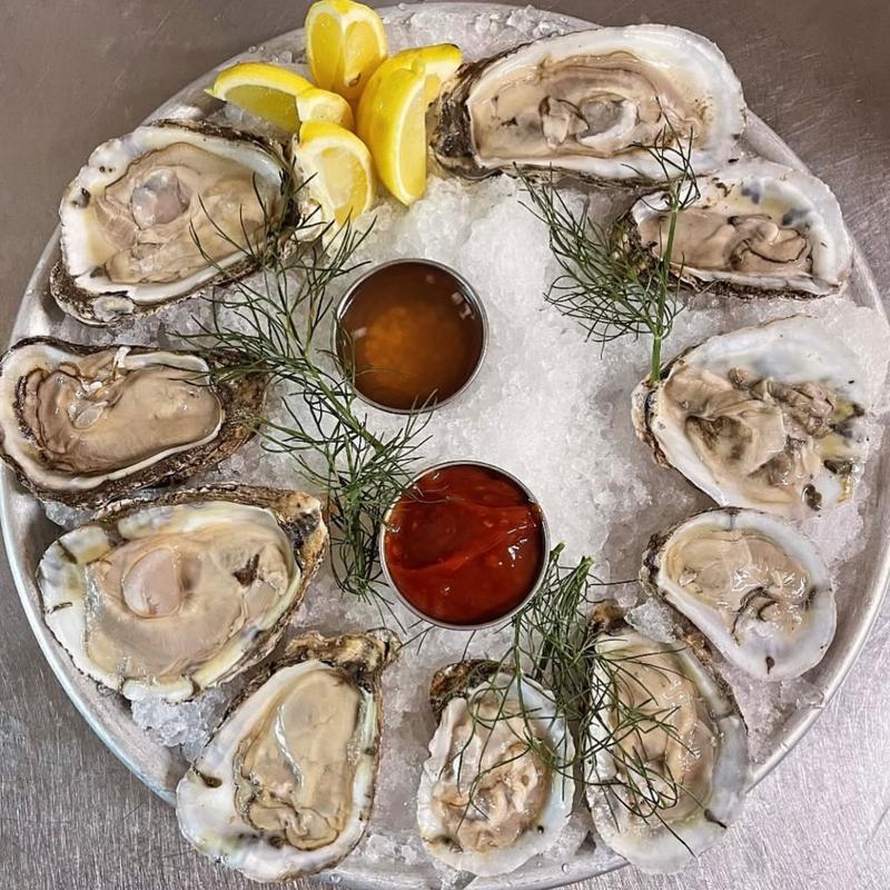 Freshly shucked oysters on ice with mignonette and cocktail sauce at Harper's