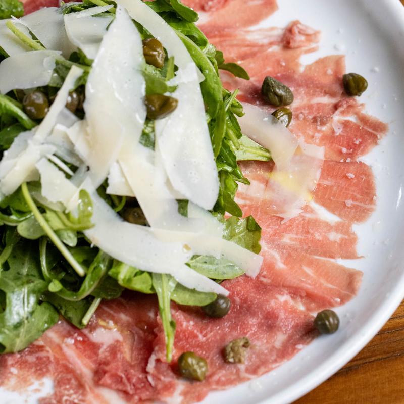 Beef carpaccio with arugula, shaved parmesan and capers at Harper's