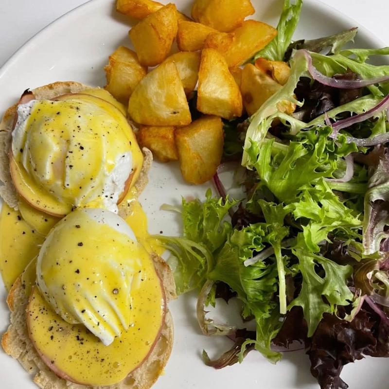 Eggs Benedict with home fries and a mixed green salad at Harper's