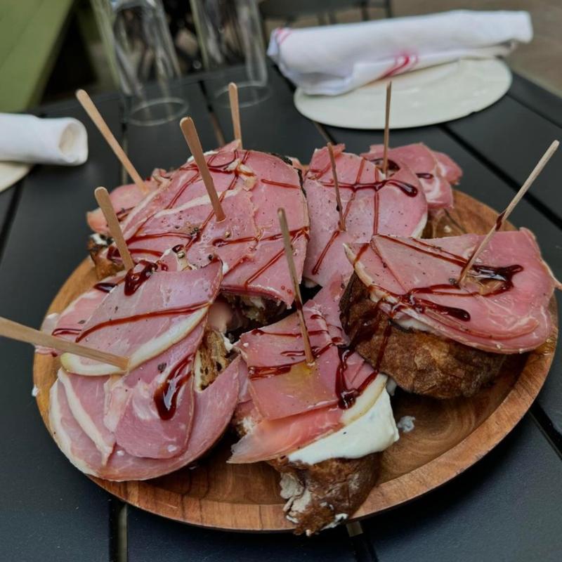 Prosciutto and burrata crostini with balsamic glaze on the patio at Harper's